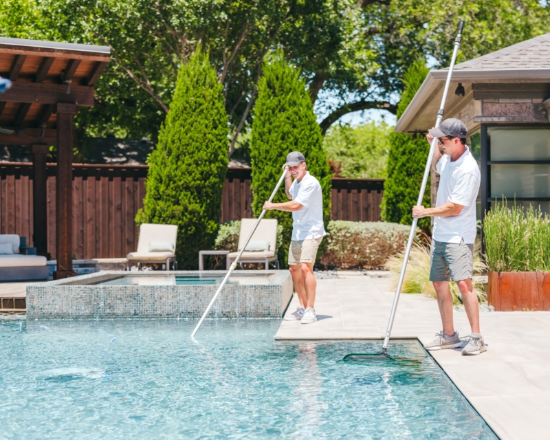 Miller Pools staff cleaning a swimming pool